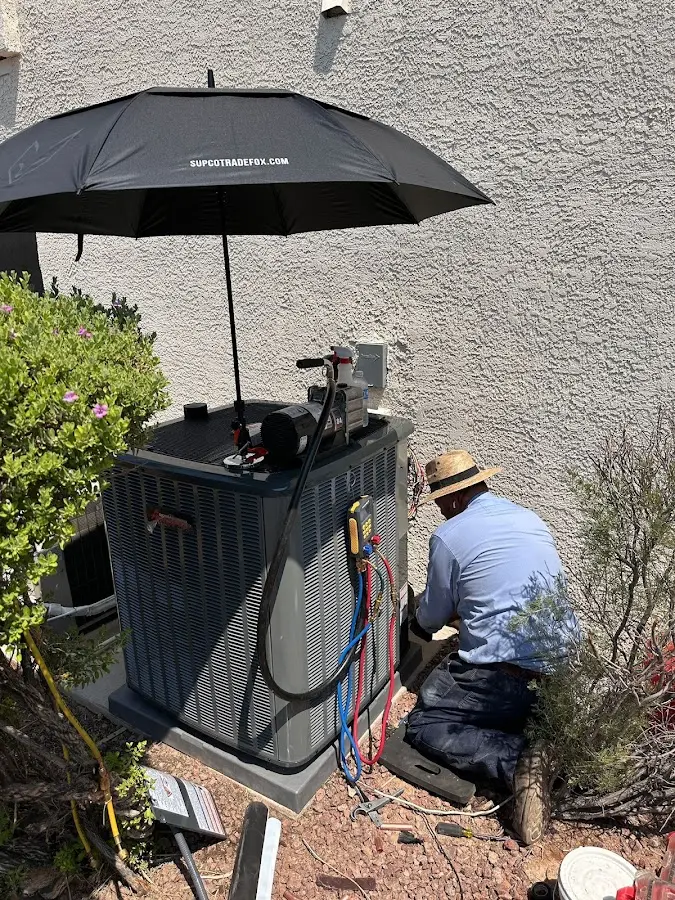 HVAC technician performing outdoor AC maintenance in Mililani Mauka